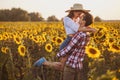 Loving couple in a blooming sunflower field Royalty Free Stock Photo