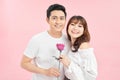 Loving couple. Cheerful young loving couple standing close to each other while woman holding a red rose in her hand Royalty Free Stock Photo