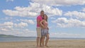 Loving couple on the coast, dancing. This is their love story. They hug and kiss. A man and a woman are happy and joyful Royalty Free Stock Photo