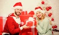 Loving couple cuddle smiling while unpacking gift christmas tree background. Family prepared christmas gifts. Opening