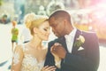 Loving couple of cute bride and african American groom