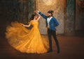 loving couple is dancing at fairy ball. Happy beauty woman fantasy princess in yellow dress and guy is enchanted beast Royalty Free Stock Photo