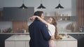 Loving couple dancing slowly at kitchen. Two fancy people enjoying time together Royalty Free Stock Photo