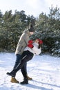 Loving couple dancing in winter forest. Frosty clear day. Vertical frame Royalty Free Stock Photo