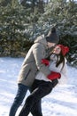 Loving couple dancing in winter forest. Walk on frosty clear day. Vertical frame Royalty Free Stock Photo