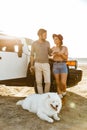Loving couple with dog samoyed outdoors Royalty Free Stock Photo