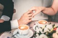 Loving couple drink coffee after the wedding. Hands newlyweds