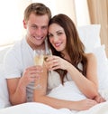 Loving couple drinking champagne lying in bed Royalty Free Stock Photo
