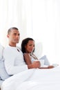 Loving couple drinking a coffee on their bed Royalty Free Stock Photo