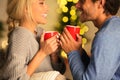 Loving couple drinking tea and enjoying winter holidays Royalty Free Stock Photo