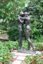 Loving couple embraces. Monument in the park.