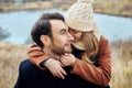 Loving couple embracing in the field, autumn landscape. Man and woman in autumn clothes in nature, love and tenderness in touch Royalty Free Stock Photo