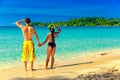 A loving couple enjoying the breathtaking views of the tropical sandy beach Royalty Free Stock Photo