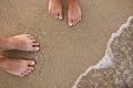 Loving couple feet in the sand Royalty Free Stock Photo