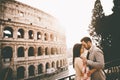 Loving couple in front of the Colosseum in Rome