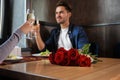 Loving couple with glasses of champagne in restaurant on romantic date Royalty Free Stock Photo