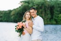 A loving couple a guy and a girl are standing on the Bank of a river or lake Royalty Free Stock Photo