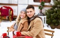 Loving couple having romantic date in camping, enjoying picnic under falling snow Royalty Free Stock Photo