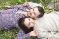 A loving couple of hipsters lay on the grass Royalty Free Stock Photo