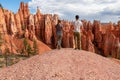 Loving couple holding hands with scenic aerial view of hoodoo sandstone rock formations on Queens Garden trail, Utah Royalty Free Stock Photo