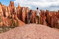 Loving couple holding hands with scenic aerial view of hoodoo sandstone rock formations on Queens Garden trail, Utah Royalty Free Stock Photo