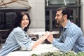 Loving couple holding hands sitting at table in cafe. Royalty Free Stock Photo