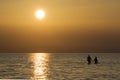 Couple holding hands at sunset