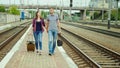 A loving couple holds hands. Go together along the okla along the railway