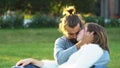 Loving couple hugs and kisses while sitting on the grass in the park. Concept. Sweet and beautiful man and woman Royalty Free Stock Photo