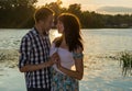 A loving couple - husband and wife, in the rays of sunset near t Royalty Free Stock Photo