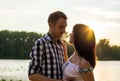 A loving couple - husband and wife, in the rays of sunset near t Royalty Free Stock Photo