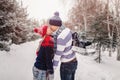 Loving couple kissing on a date in a winter Park. On the back of a guy hangs a pair of skates.