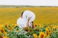 Loving couple kissing in a field of sunflowers. Family spending time together on nature. selective focus Royalty Free Stock Photo