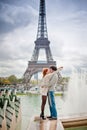 Loving couple kissing near the Eiffel Tower in Paris Royalty Free Stock Photo