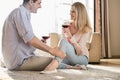 Loving couple looking at each other while drinking red wine at home Royalty Free Stock Photo