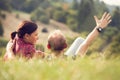 Loving couple lying in green grass on the meadow Royalty Free Stock Photo