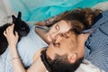 Loving couple lying near the window with a rabbit on his hands. Tender and romantic feelings of the newlyweds. Beautiful woman Royalty Free Stock Photo