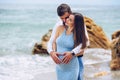 Loving couple making heart shape on the pregnant belly with their hands. Royalty Free Stock Photo