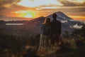 A loving couple, a man and a woman stands near Batur volcano. Sunrise, sunset Royalty Free Stock Photo