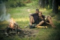 Loving couple in nature. Couple in love look at campfire in wood