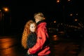 Loving couple in night sity. Red-haired girl