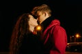 Loving couple in night sity. Red-haired girl