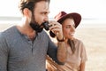 Loving couple outdoors at the beach near car drinking tea Royalty Free Stock Photo