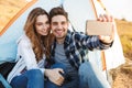 Loving couple outside in free alternative vacation camping take selfie by mobile phone