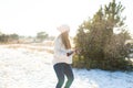 Loving couple play snowballs in winter in the forest. Girl sculpts and throws snowballs. Laugh and have a good time Royalty Free Stock Photo