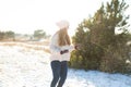 Loving couple play snowballs in winter in the forest. Girl sculpts and throws snowballs. Laugh and have a good time Royalty Free Stock Photo