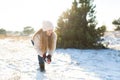 Loving couple play snowballs in winter in the forest. Girl sculpts and throws snowballs. Laugh and have a good time Royalty Free Stock Photo