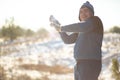 Loving couple play snowballs in winter in the forest. The guy sculpts and throws snowballs at the girl. Laugh and have a good time Royalty Free Stock Photo