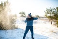 Loving couple play snowballs in winter in the forest. The guy sculpts and throws snowballs at the girl. Laugh and have a good time Royalty Free Stock Photo