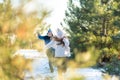 Loving couple play snowballs in winter in the forest. The guy sculpts and throws snowballs at the girl. Laugh and have a good time Royalty Free Stock Photo